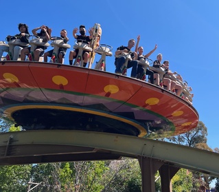 Riders seated on the Tiki Twirl attraction while it's in motion