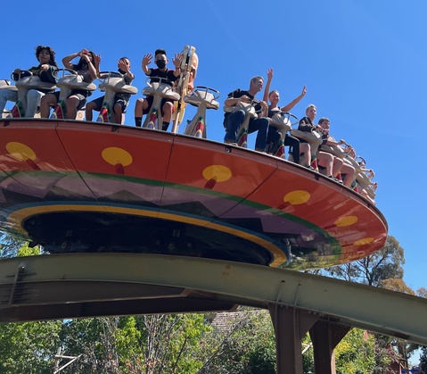 Riders seated on the Tiki Twirl attraction while it's in motion